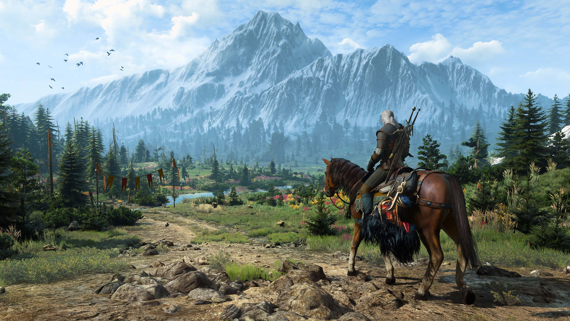 Geralt and Roach overlooking a valley beneath snowy mountains